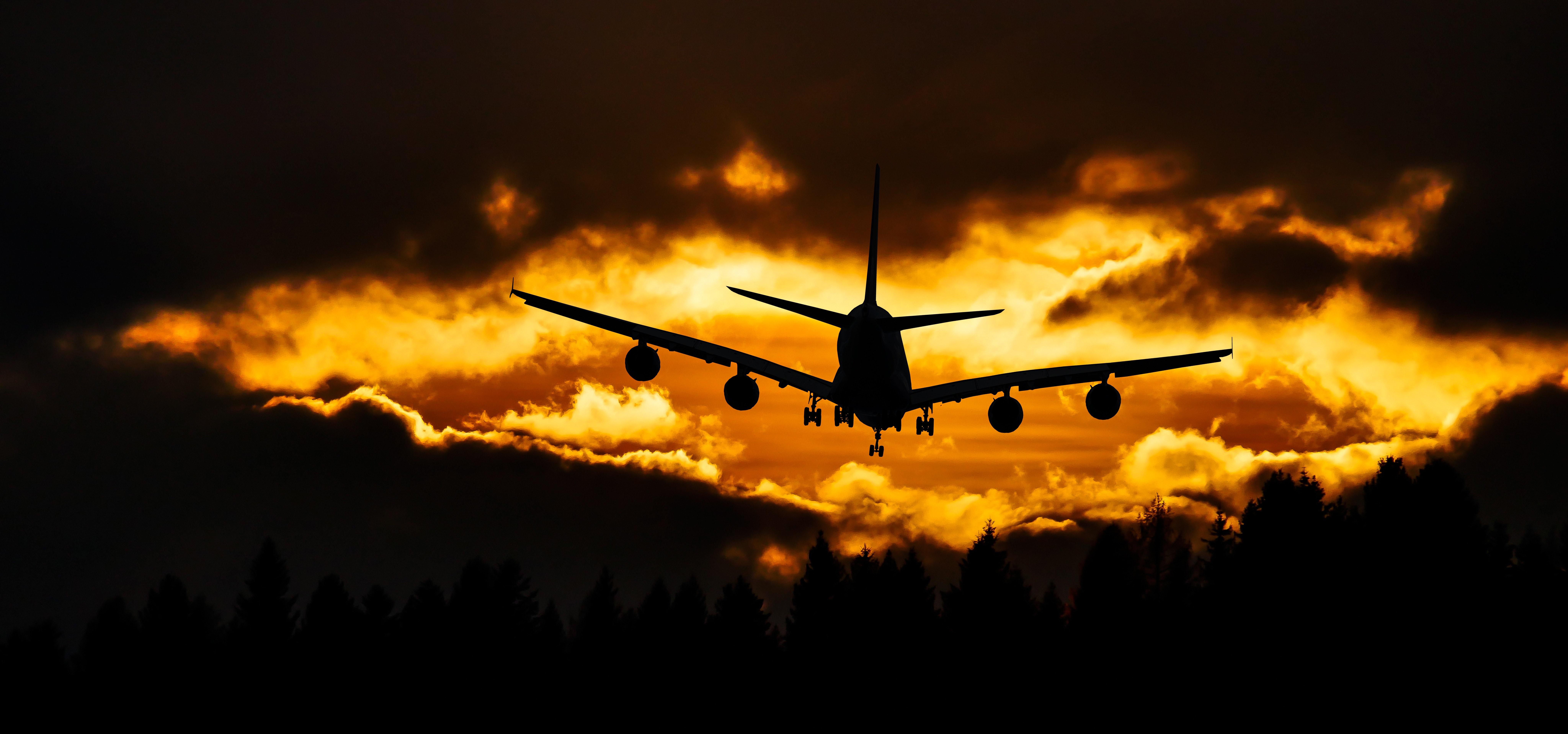 Airplane in air during sunset