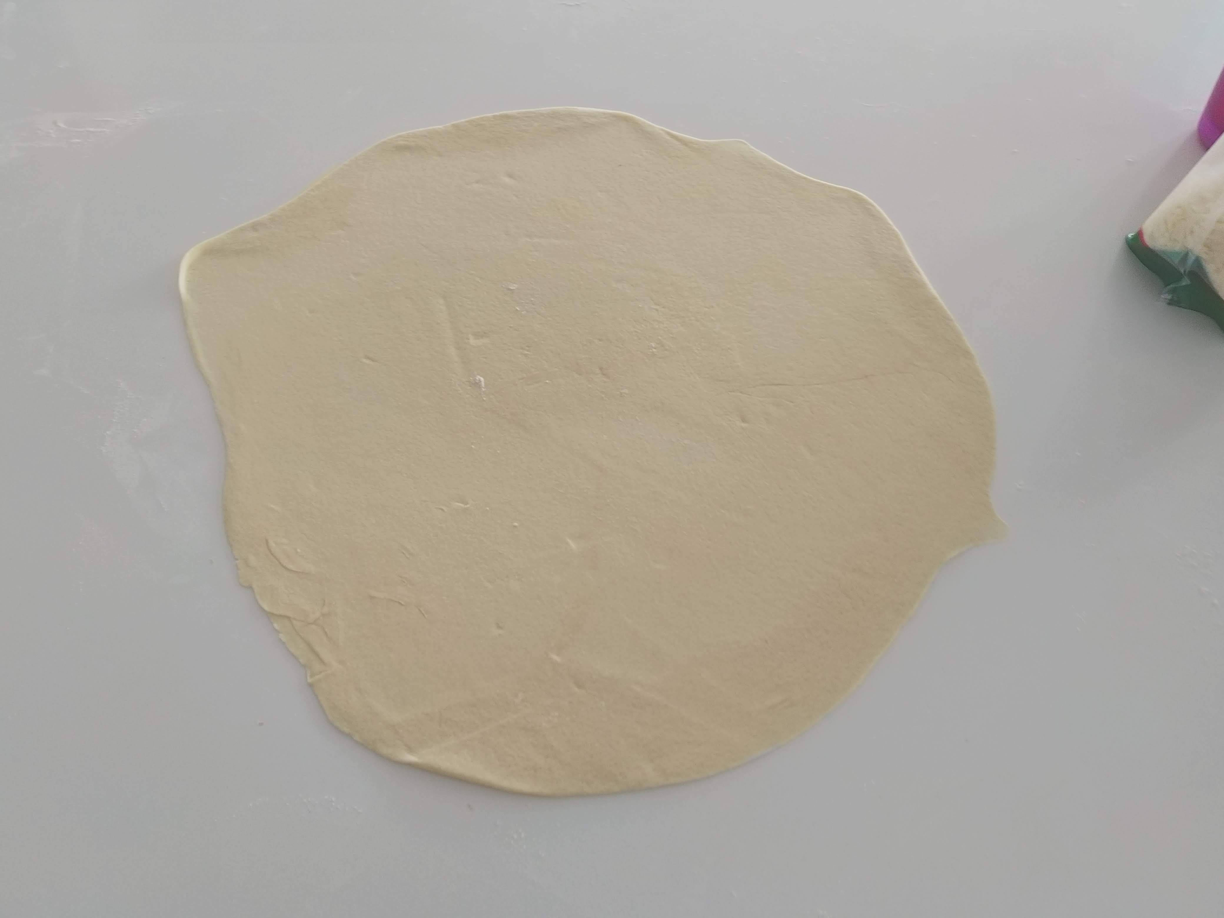 Pizza dough rolled out