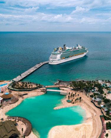 White cruise ship docked near beach