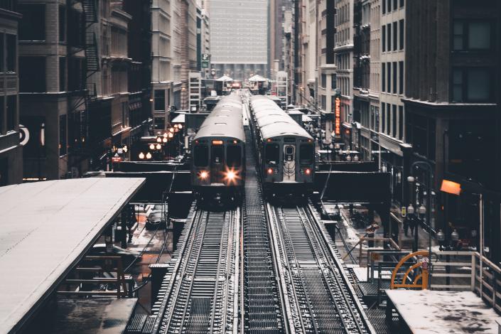 Two trains between buildings