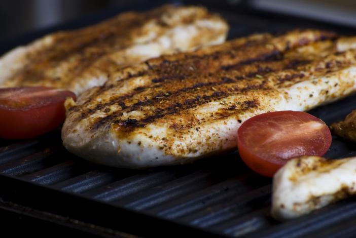 Chicken and tomatoes on grill