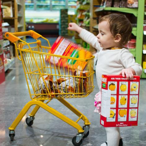 Girl standing beside cart