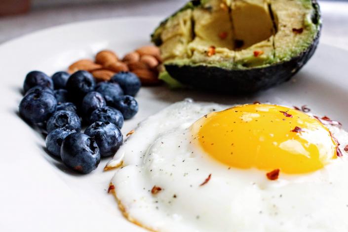 Eggs with blueberries and avocado