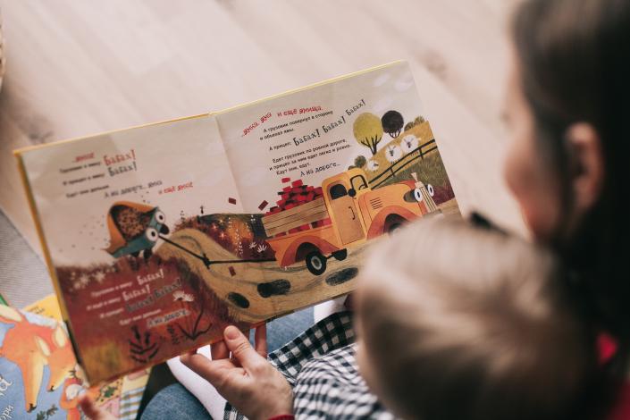 Woman reading book to child