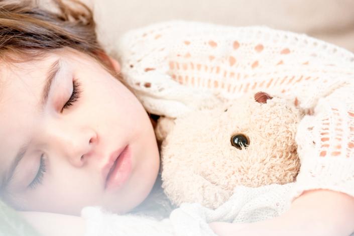 Girl sleeping with teddy bear