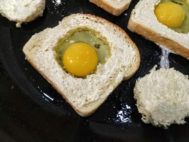 Bread with egg in the middle in frying pan