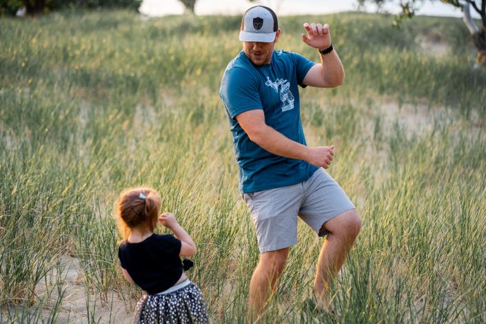 Man dancing with little girl