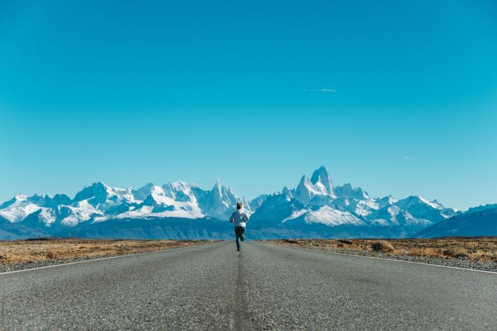 Man running towards mountains