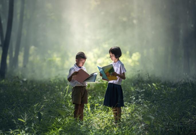 Kids standing and reading books