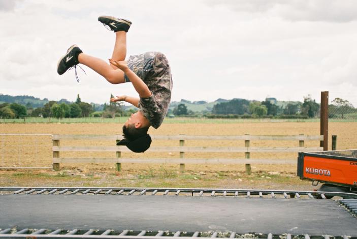 Child doing flip on a trampoline