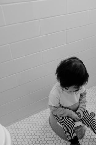 Child sitting on toilet