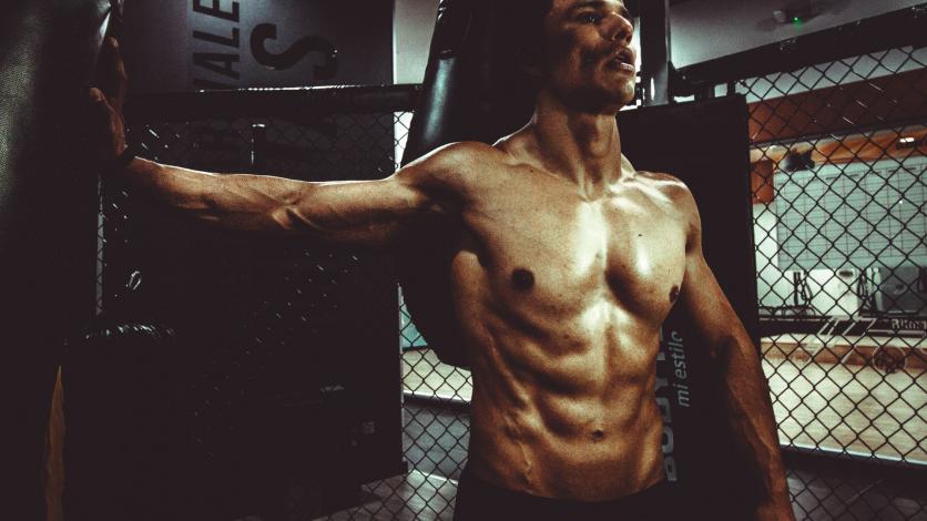 Man working out without shirt showing six pack