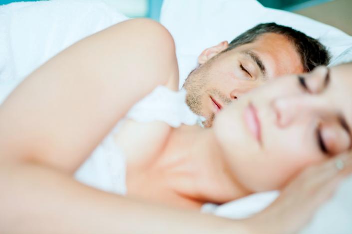 Man and woman sleeping in bed