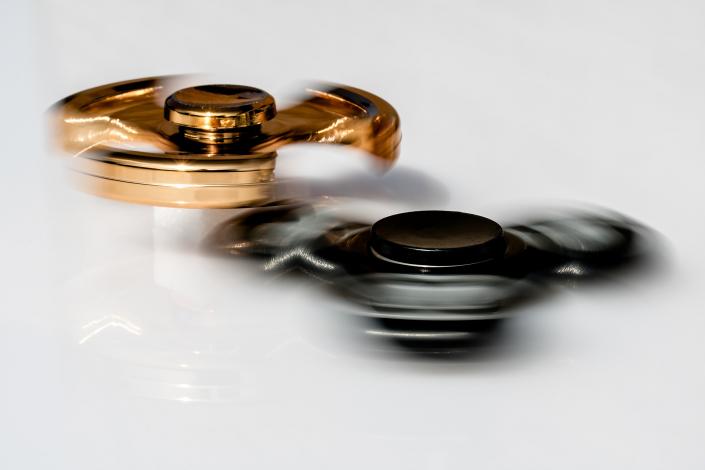 Black and gold fidget spinners spinning