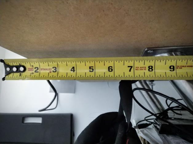 Tape measure showing distance under desk