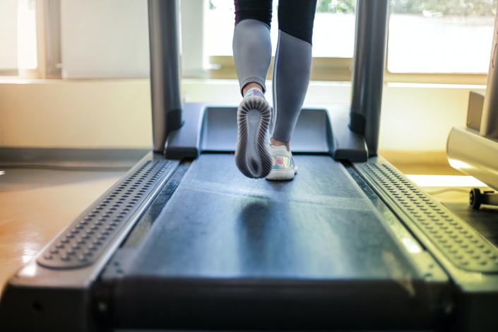 Feet walking on treadmill
