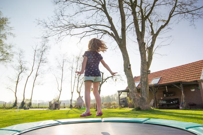 Girl jumping on trampoline