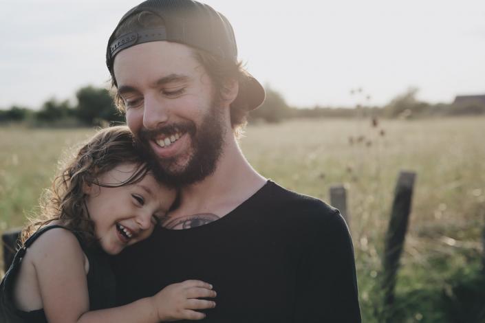 Father holding daughter