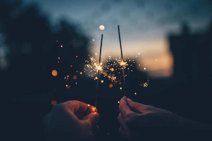 Two sparklers being held