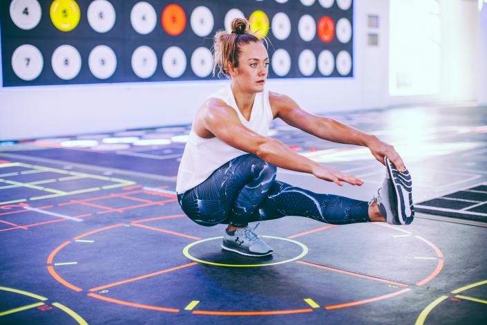 Woman doing single leg balancing squat