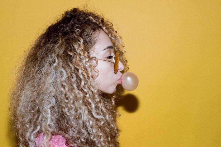 Woman blowing bubble with gum