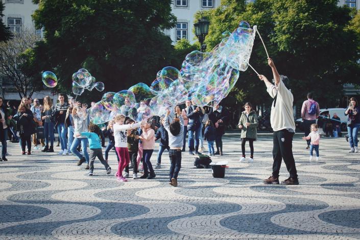 Man using bubble wand with kids