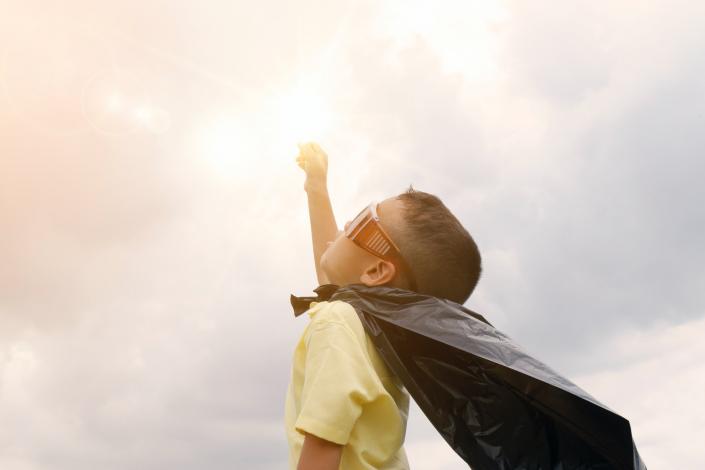 Child in cape and glasses