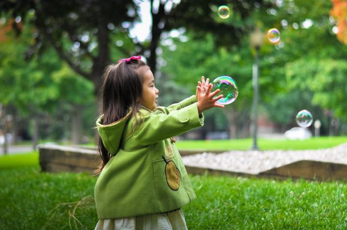 Girl catching bubbles