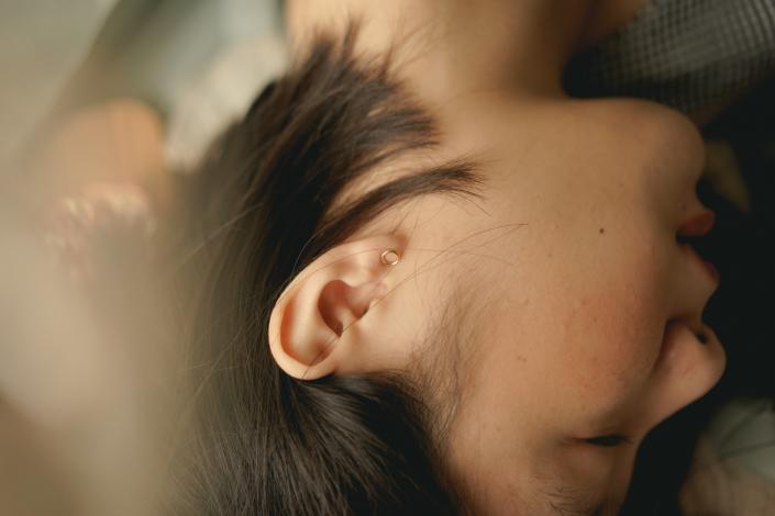 Side of woman's head laying down