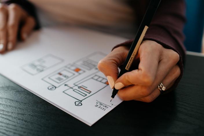 Person drawing a plan
