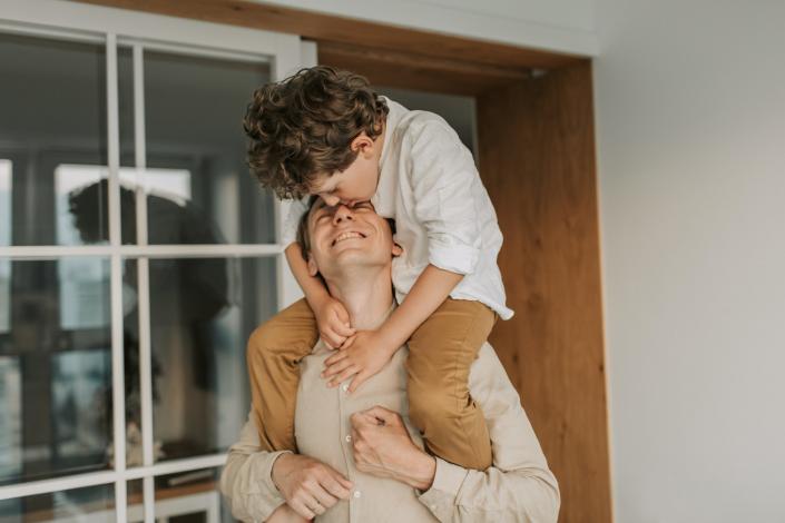 Man holding son on shoulders