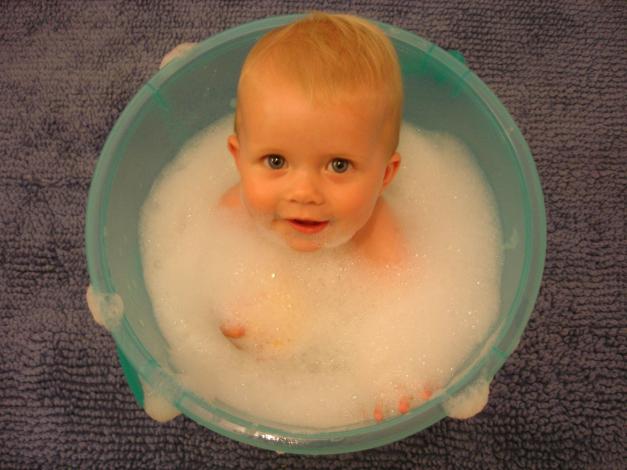 Baby in bucket of bubbles