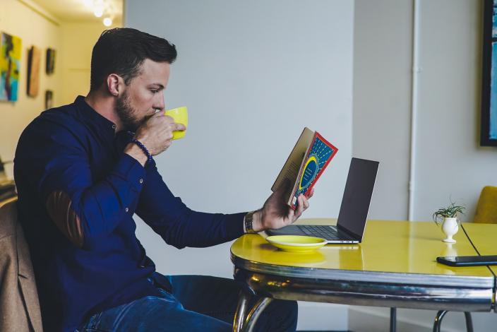 Person reading and drinking