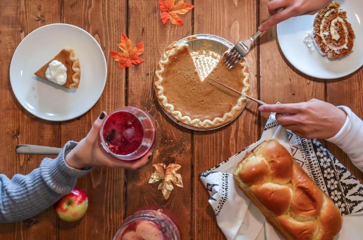 Person slicing pumpkin pie