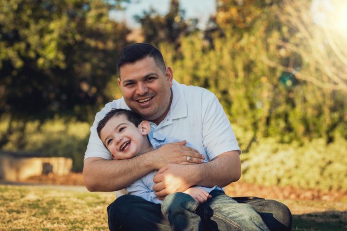 Father and son sitting on ground