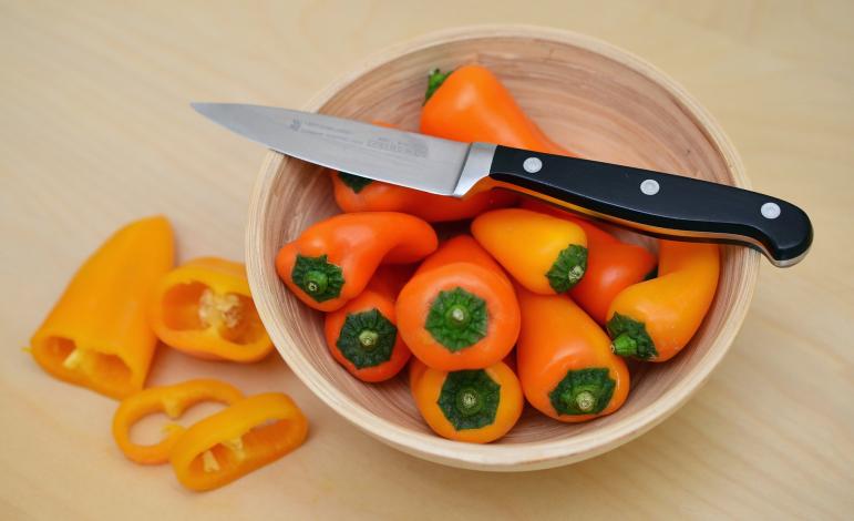 Mini bell peppers in bowl with knife