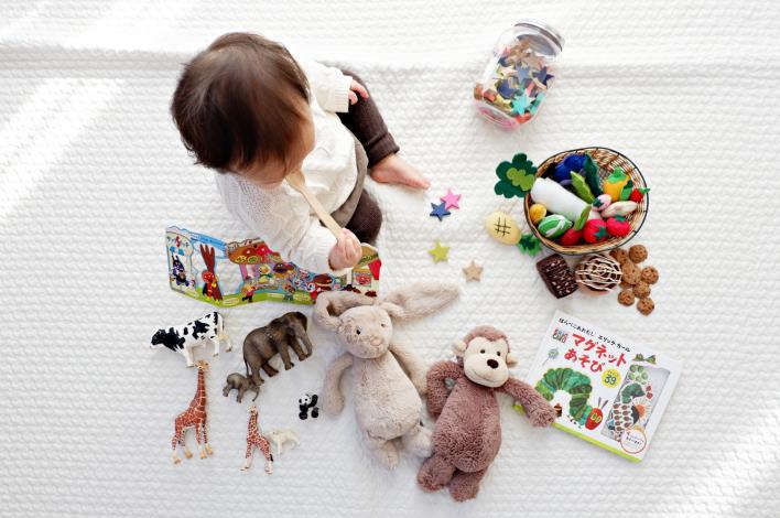 Baby sitting with toys