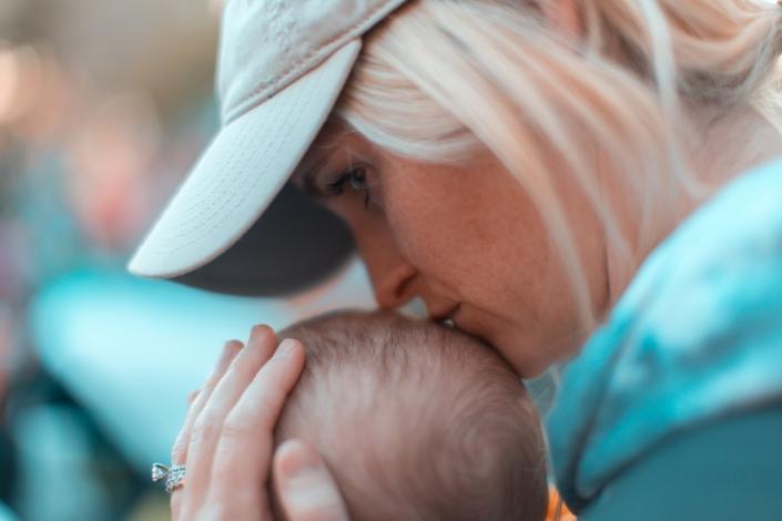 Woman kissing baby