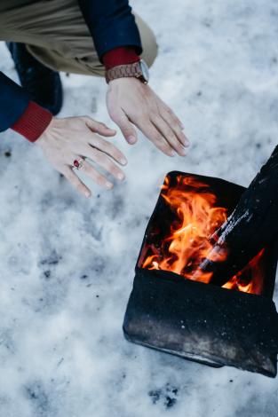 Getting warm by fire in snow