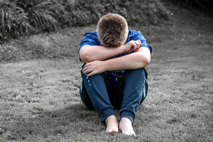 Boy sitting on ground