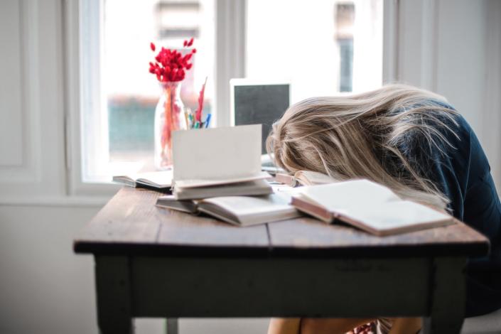 Girl with head on desk