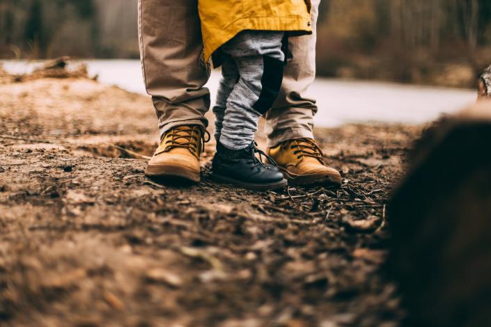 Child and adults feet on ground