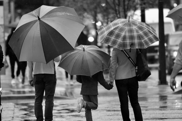 Family holding umbrellas