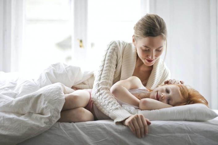 Daughter and mother in bed