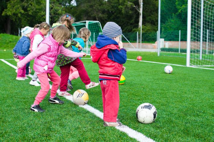 Kids kicking soccer balls