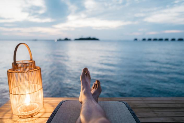 Person's feet looking at a lake