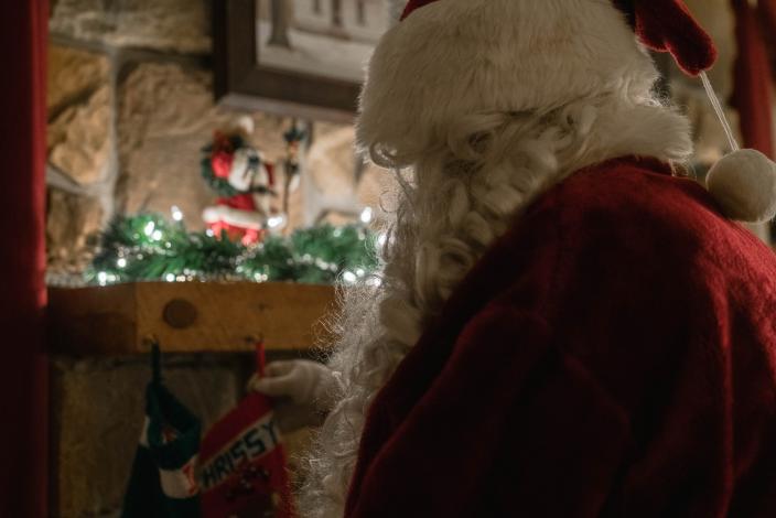 Santa Claus looking at a stocking