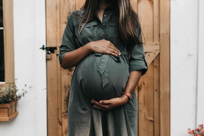 Pregnant women holding belly