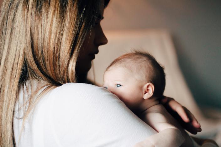 Mother holding new baby