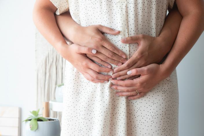 Man holding wife's belly